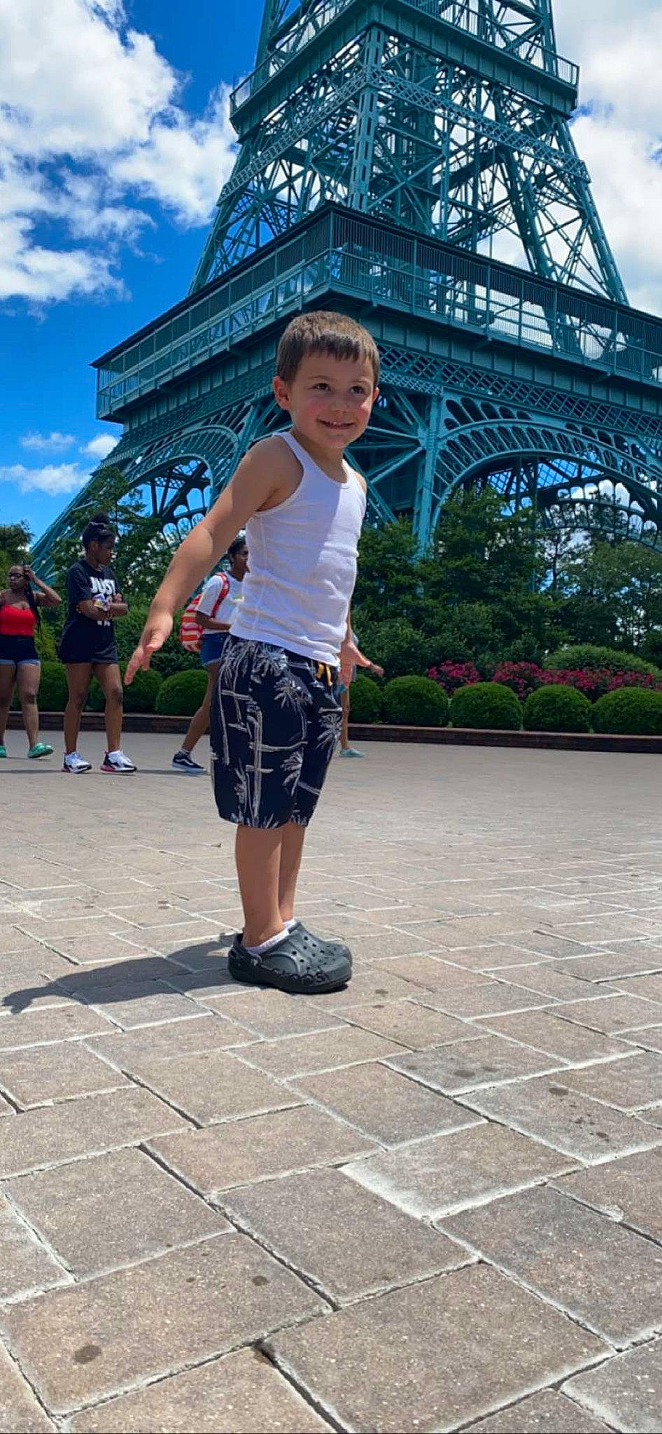 Brandon is registered to the contest to win money with this photo: architecture, asphalt, city, cloud, electric_blue, flooring, fun, headwear, human_leg, joy, leg, leisure, pedestrian, person, plant, recreation, road_surface, shorts, sky, street_fashion