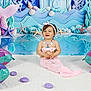 Anna a rejoint le concours — aidez-le/la à gagner de superbes lots ! toddler, child, mermaid, costume, pink, inflatable, seashell, starfish, underwater, backdrop, smiling, headband, necklace, white_rug, playful, indoor, photography, cute, happy, fantasy