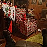 armchair, blanket, carpet, cat, christmas, christmas_tree, cozy, feline, furniture, holiday, home_decor, indoor, living_room, ornaments, pet, portrait, quilt, radiator, stocking, wood_paneling