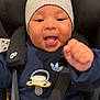 Ismaïl participe au concours pour gagner de l'argent avec cette photo : baby, child, car_seat, knit_hat, pacifier, navy_sweatshirt, jeans, happy, smiling, fist, straps, infant, cute, indoors, seatbelt, young_child, clothing, person, portrait, closeup