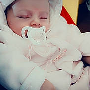 Sileyna participe au concours pour gagner de l'argent avec cette photo : baby, sleeping, pacifier, white_clothing, hooded_outfit, hand, infant, closeup, soft_texture, indoor, peaceful, cute, child, warm_clothing, face, adorable, newborn, resting, cozy, portrait