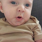 Noha participe au concours pour gagner de l'argent avec cette photo : baby, infant, face, blue_eyes, light_hair, beige_shirt, hand, skin, close_up, expression, child, person, couch, indoor, portrait, cute, young, human, finger, sitting