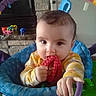 Kennedy joined the competition — help win amazing prizes! activity_seat, baby, brown_hair, child, colorful, eyes, face, fireplace, hands, happy, indoor, infant, playroom, portrait, red_toy, sitting, striped_shirt, teething_toy, toy, yellow_clothing