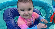 Kennedy joined the competition — help win amazing prizes! baby, child, infant, smiling, face, portrait, swimming, pool, inflatable_pool, float, water, outdoor, summer, colorful, pink_clothing, blue_clothing, playtime, sitting, happy, photography