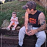 Kennedy joined the competition — help win amazing prizes! baby, child, father, parent, outdoor, backyard, grass, log, seated, smiling, portrait, family, camouflage_hat, tattoos, sleeveless_shirt, pink_dress, sippy_cup, sneakers, stairs, photography