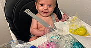 Ashton is registered to the contest to win money with this photo: art_project, baby, child, colorful, door_handle, face, fun, happy, high_chair, indoor, messy, paint, painting, paper_towels, plastic_bags, seatbelt, smiling, table, white_wall, young_child