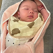 Xuân Lan participe au concours pour gagner de l'argent avec cette photo : baby, sleeping, blanket, bib, infant, cozy, soft, pink, face, head, clothing, person, cute, peaceful, indoors, rest, newborn, wrapped, comfort, relaxation