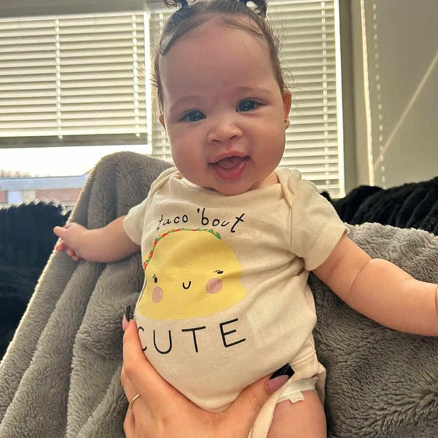 Nakaila is registered to the contest to win money with this photo: baby, blanket, bodypart, clothing, couch, cushion, face, furniture, happy, head, homedecor, laughing, newborn, pants, person, photography, portrait, shorts, smile, t_shirt