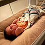 arms, baby, bassinet, blanket, clothing, comfort, cushion, face, head, indoor, infant, mesh, newborn, peaceful, quiet, resting, skin, sleeping, soft, striped