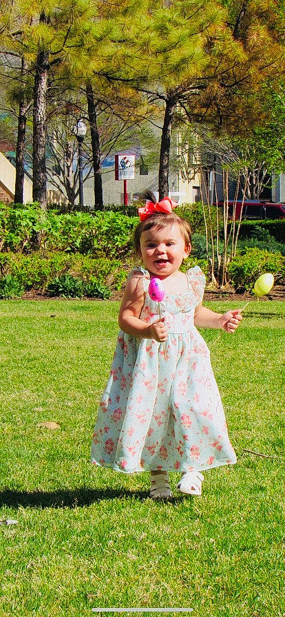 Armoni is registered to the contest to win money with this photo: baby, baby_toddler_clothing, child, clothing, day_dress, dress, event, fun, garden, grass, happy, lawn, leisure, one_piece_garment, people_in_nature, person, plant, recreation, smile, toddler