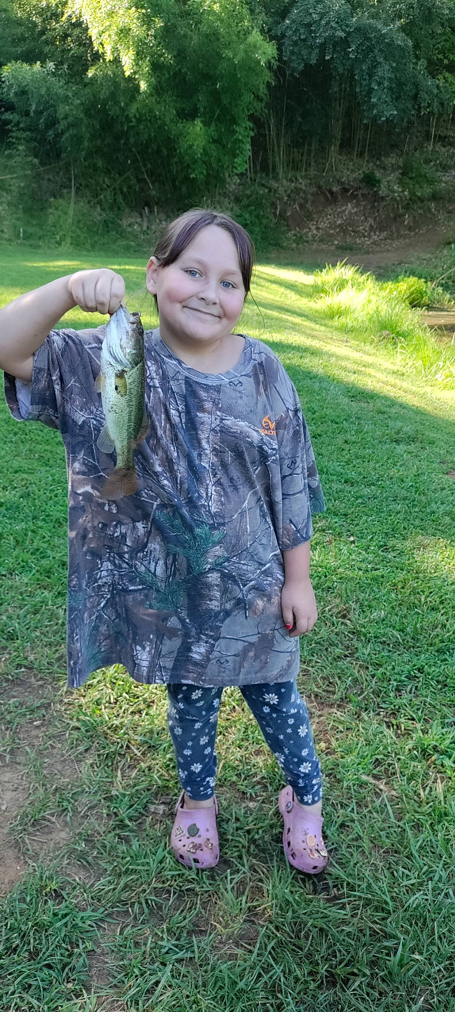 Bethany joined the competition — help win amazing prizes! child, denim, fashion_accessory, fish, grass, grassland, joy, pattern, people_in_nature, person, plant, python, recreation, reptile, sandal, scaled_reptile, sleeve, smile, soil, t_shirt