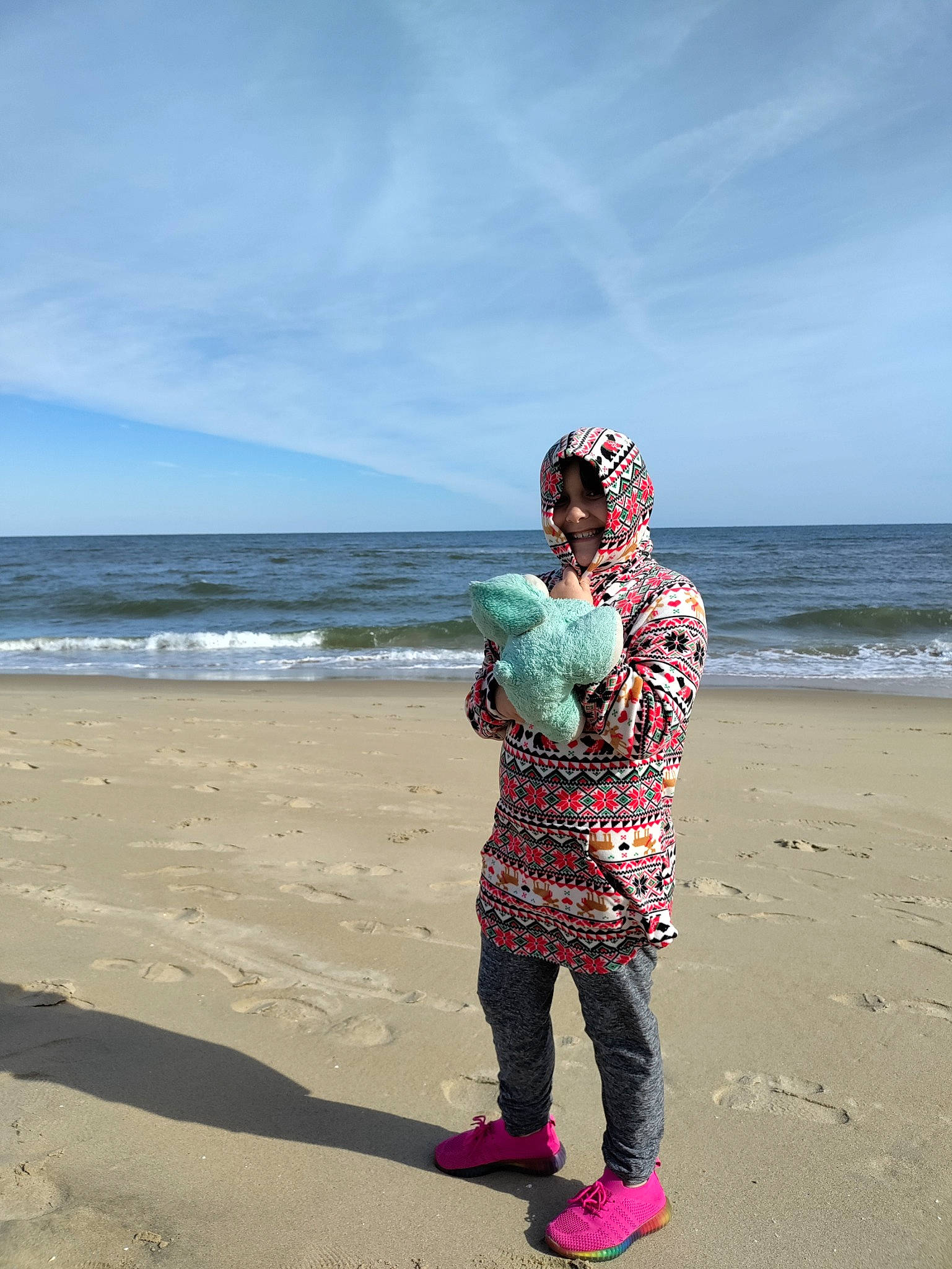 Bethany is registered to the contest to win money with this photo: beach, cloud, fun, gesture, happy, hat, holiday, horizon, joy, landscape, leisure, ocean, people_in_nature, people_on_beach, person, sand, sky, toddler, travel, water