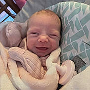 Aubree joined the competition — help win amazing prizes! baby, newborn, smile, blanket, pacifier, cushion, infant, face, sleepwear, comfort, cute, soft, resting, indoors, child, person, cozy, head, happy, wrapped