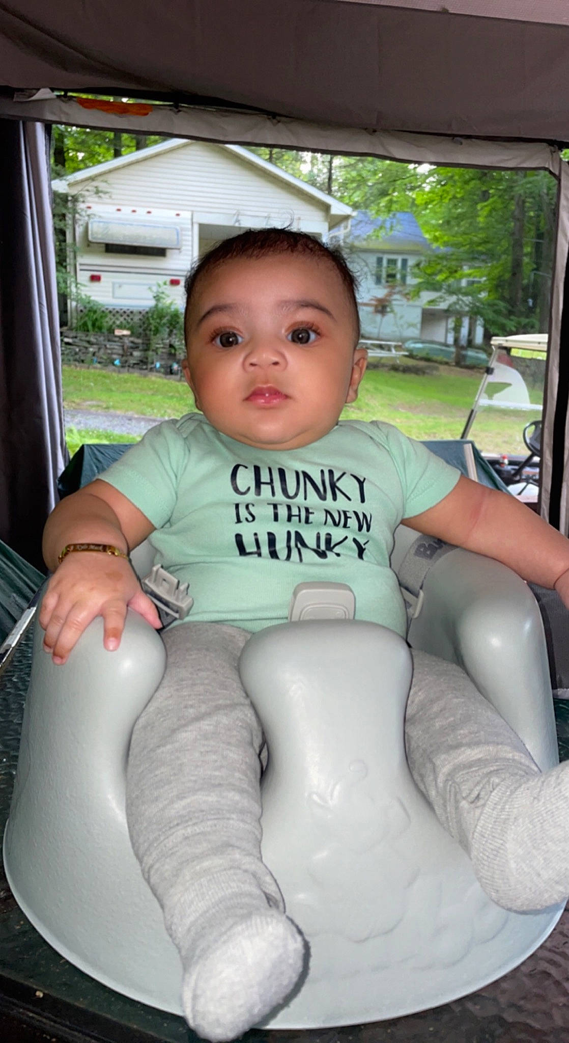 Kylo is registered to the contest to win money with this photo: auto_part, baby, baby_toddler_clothing, black_hair, car_seat, comfort, finger, grass, knee, leg, leisure, person, plant, skin, sleeve, steering_wheel, thigh, toddler, tree, trunk