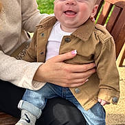 Cody joined the competition — help win amazing prizes! baby, bench, casual_clothing, child, cute, daylight, grass, hand, happy, holding, human, jacket, jeans, outdoor, person, portrait, seated, smiling, socks, young_child