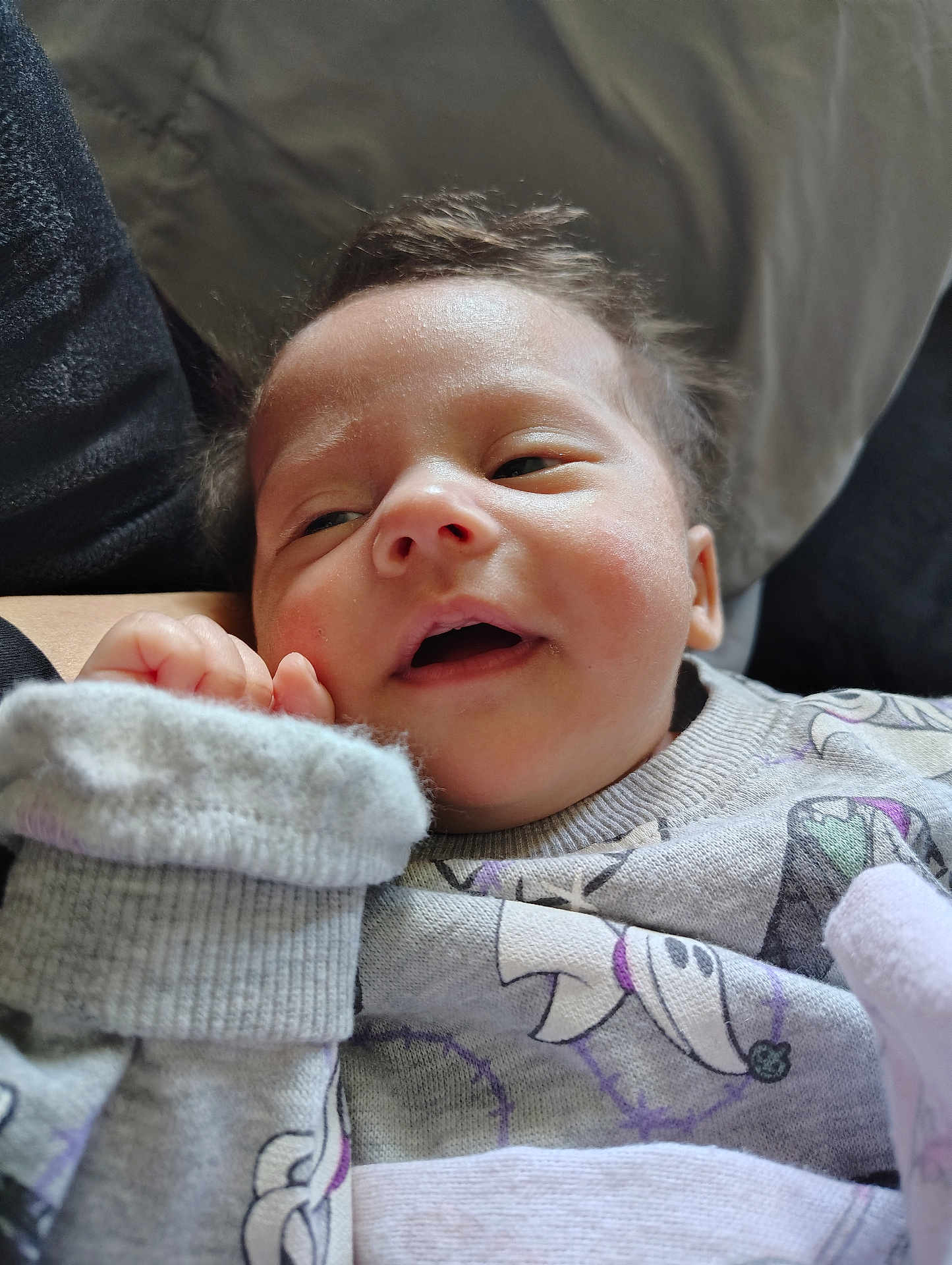 Riley is registered to the contest to win money with this photo: baby, infant, face, hand, clothing, onesie, sleepy, expression, closeup, soft_texture, fuzzy, person, cute, child, indoors, warm, comfort, resting, portrait, newborn
