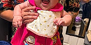 Layla joined the competition — help win amazing prizes! adult_hands, baby, bib, cartoon_characters, child, creepy_doll_print, drawer, face, floor_tiles, floral_shirt, furniture, happy, home, indoor, mirror, person, pink_dress, red_bow, reflection, smiling