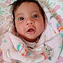baby, infant, blanket, bunny_pattern, cute, drool, face, fluffy_blanket, head, indoors, infant_clothing, looking, portrait, sleeping_area, soft_texture, toddler, wrapped, young_child, wide_eyes, youth
