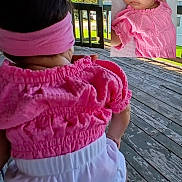 Alice is registered to the contest to win money with this photo: baby, toddler, child, pink_clothing, headband, sleeping, outdoor, wooden_deck, greenery, sunlight, portrait, infant, cute, peaceful, child_back, closeup, baby_girl, headwear, nature, daylight