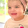 Talia is registered to the contest to win money with this photo: toddler, child, smiling, headband, curly_hair, sweater, cute, happy, portrait, face, indoors, apparel, young_child, baby, fashion, person, headwear, clothing, closeup, expression