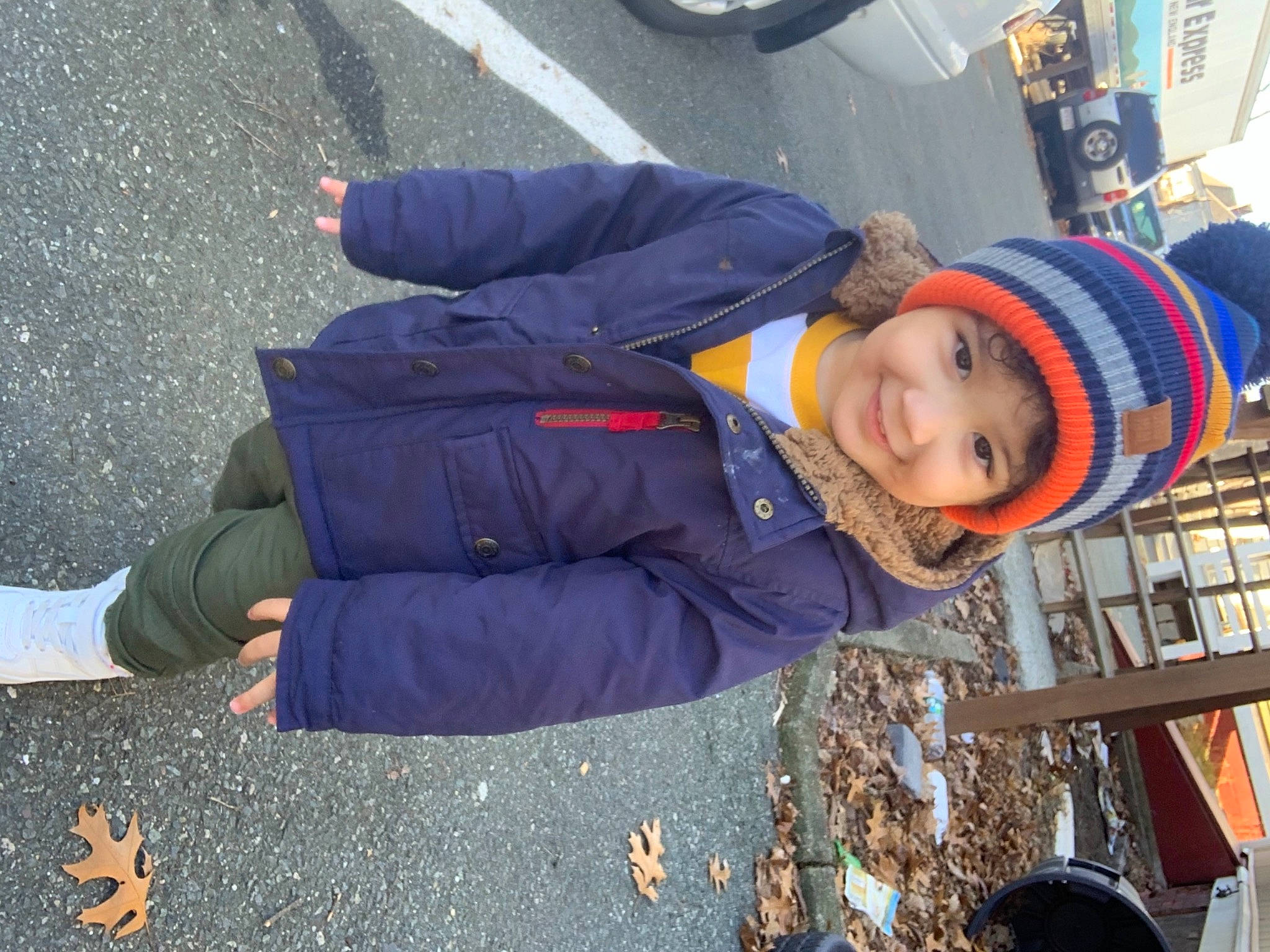 Julien is registered to the contest to win money with this photo: asphalt, automotive_tire, child, city, electric_blue, fun, glove, hat, headwear, jacket, joy, leisure, pedestrian, person, public_space, recreation, road_surface, street, street_fashion, toddler