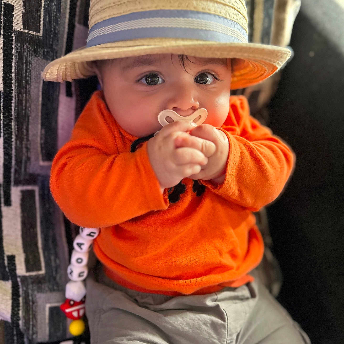 Noah joined the competition — help win amazing prizes! baby, bodypart, cap, clothing, coat, couch, cutlery, face, finger, furniture, hand, hat, head, jacket, pants, person, photography, portrait, sitting, sunhat