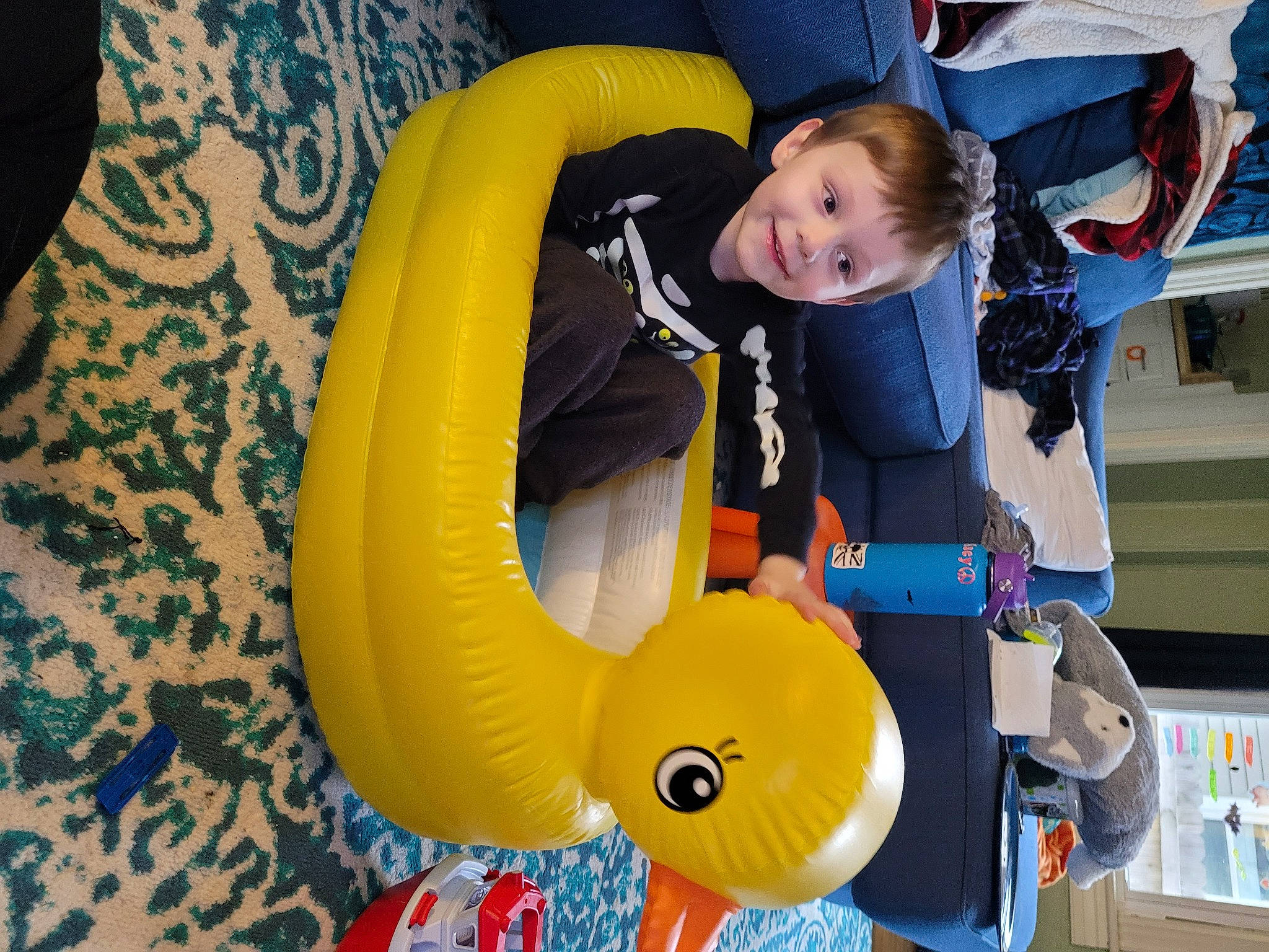 Oliver is registered to the contest to win money with this photo: baby_products, baby_toddler_clothing, comfort, inflatable, joy, person, plush, shelf, toy, yellow