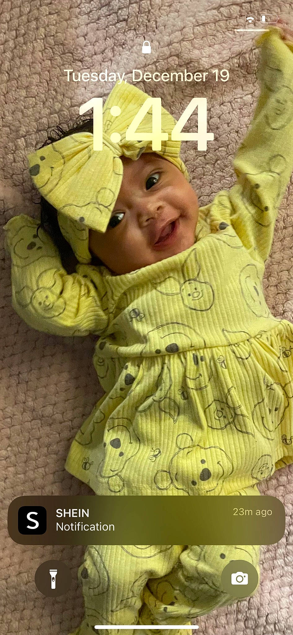 Marjhae Butler is registered to the contest to win money with this photo: arm, baby, baby_toddler_clothing, child, eye, fashion_accessory, gesture, hand, happy, head, headgear, headwear, human_body, linens, outerwear, pattern, person, sleeve, smile, t_shirt