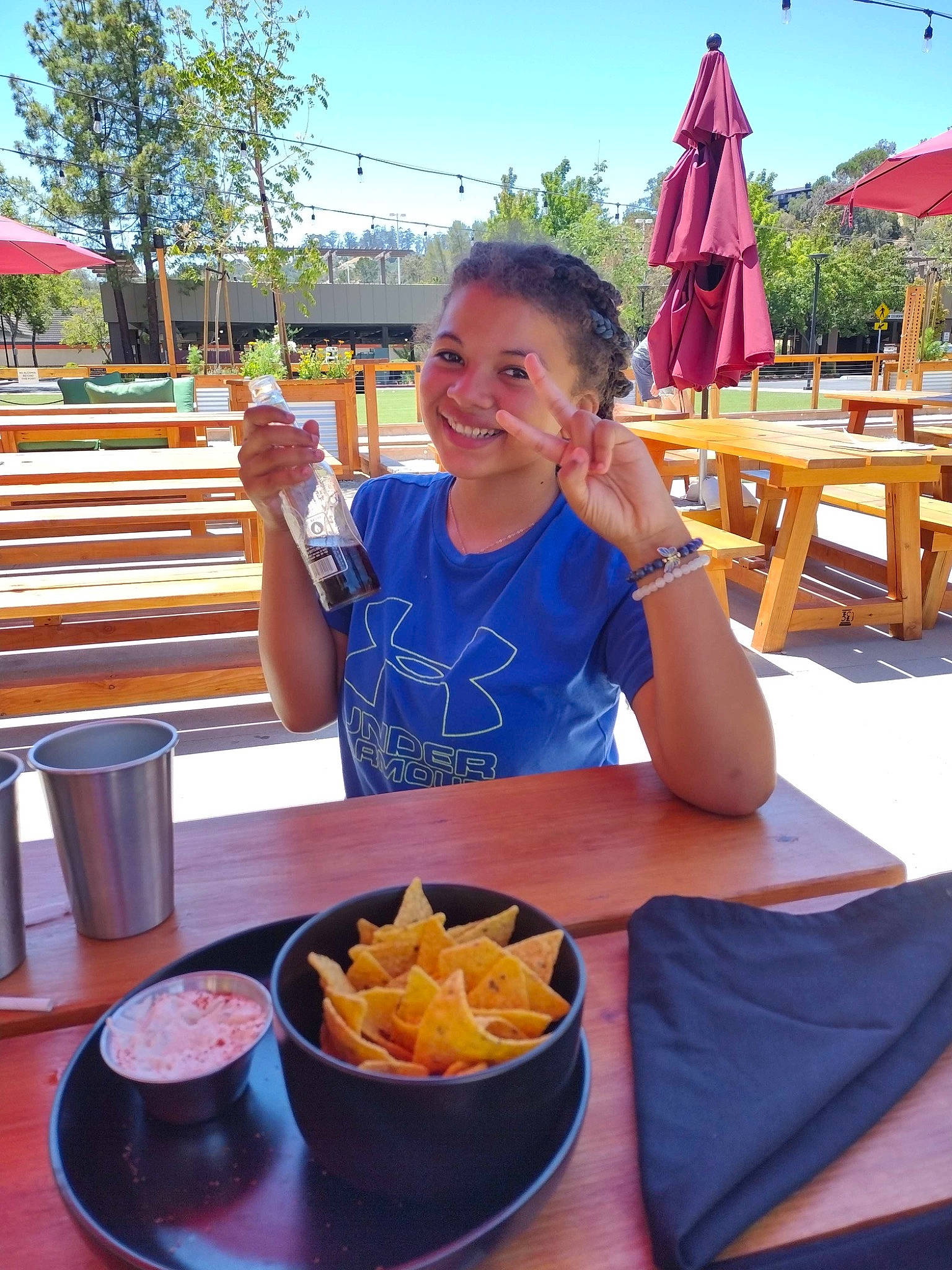 Taliyah is registered to the contest to win money with this photo: canadian_cuisine, chair, comfort_food, cuisine, dish, event, fast_food, food, french_fries, ingredient, joy, leisure, outdoor_furniture, person, plate, sky, smile, table, tableware, travel