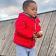 Noah Daniel participe au concours pour gagner de l'argent avec cette photo : child, kid, red_jacket, banana, food, outdoor, wood, cloudy_sky, pants, cute, portrait, person, walking, holding, young_child, casual_clothing, daytime, expression, curly_hair, nature