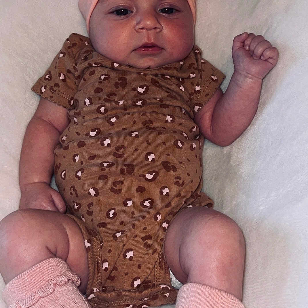 Emma is registered to the contest to win money with this photo: accessories, baby, bed, bodypart, clothing, costume, face, finger, furniture, glove, hand, hat, head, headband, hosiery, newborn, person, photography, portrait, sock