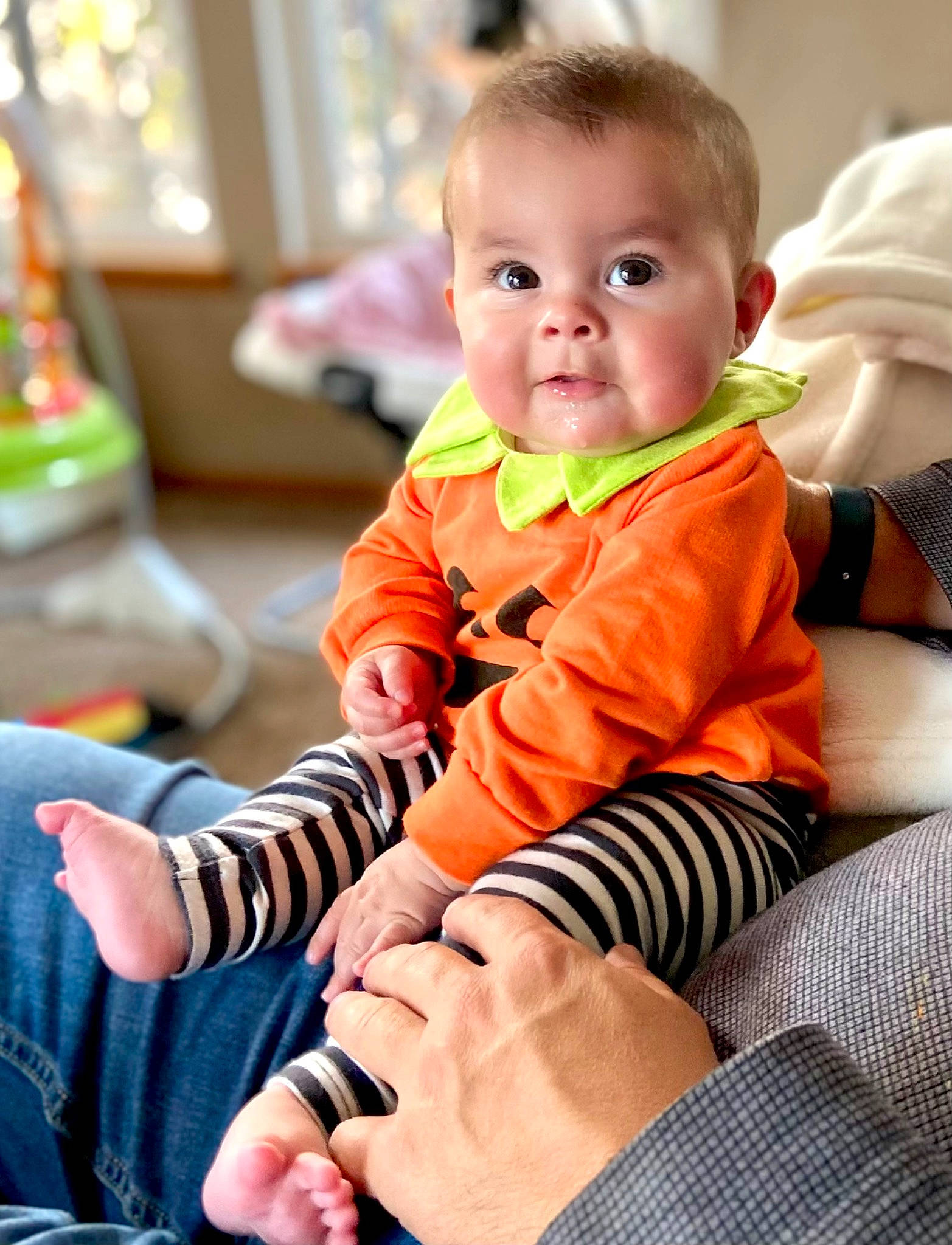 Charlotte is registered to the contest to win money with this photo: arm, baby, baby_toddler_clothing, cheek, child, comfort, event, eye, finger, flooring, fun, hand, happy, head, person, room, sitting, skin, sleeve, standing