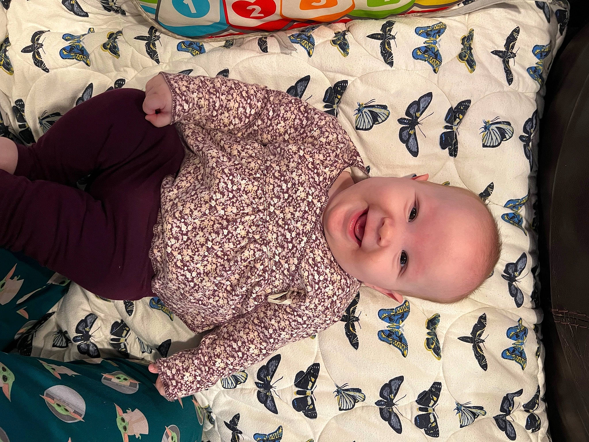 Margo is registered to the contest to win money with this photo: baby, baby_products, baby_sleeping, baby_toddler_clothing, bed, bedding, bedtime, child, comfort, flooring, happy, linens, nap, pattern, person, room, sleeve, smile, textile, toddler