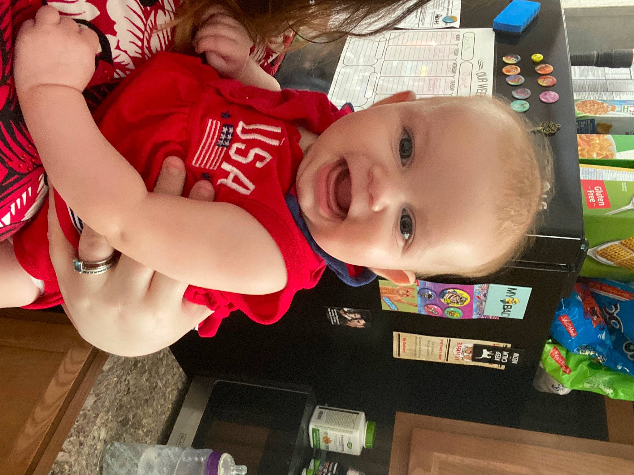 Serenity is registered to the contest to win money with this photo: baby, baby_toddler_clothing, carmine, child, fun, happy, human_leg, mouth, person, play, room, shelf, shelving, shorts, skin, smile, sportswear, t_shirt, thigh, toddler