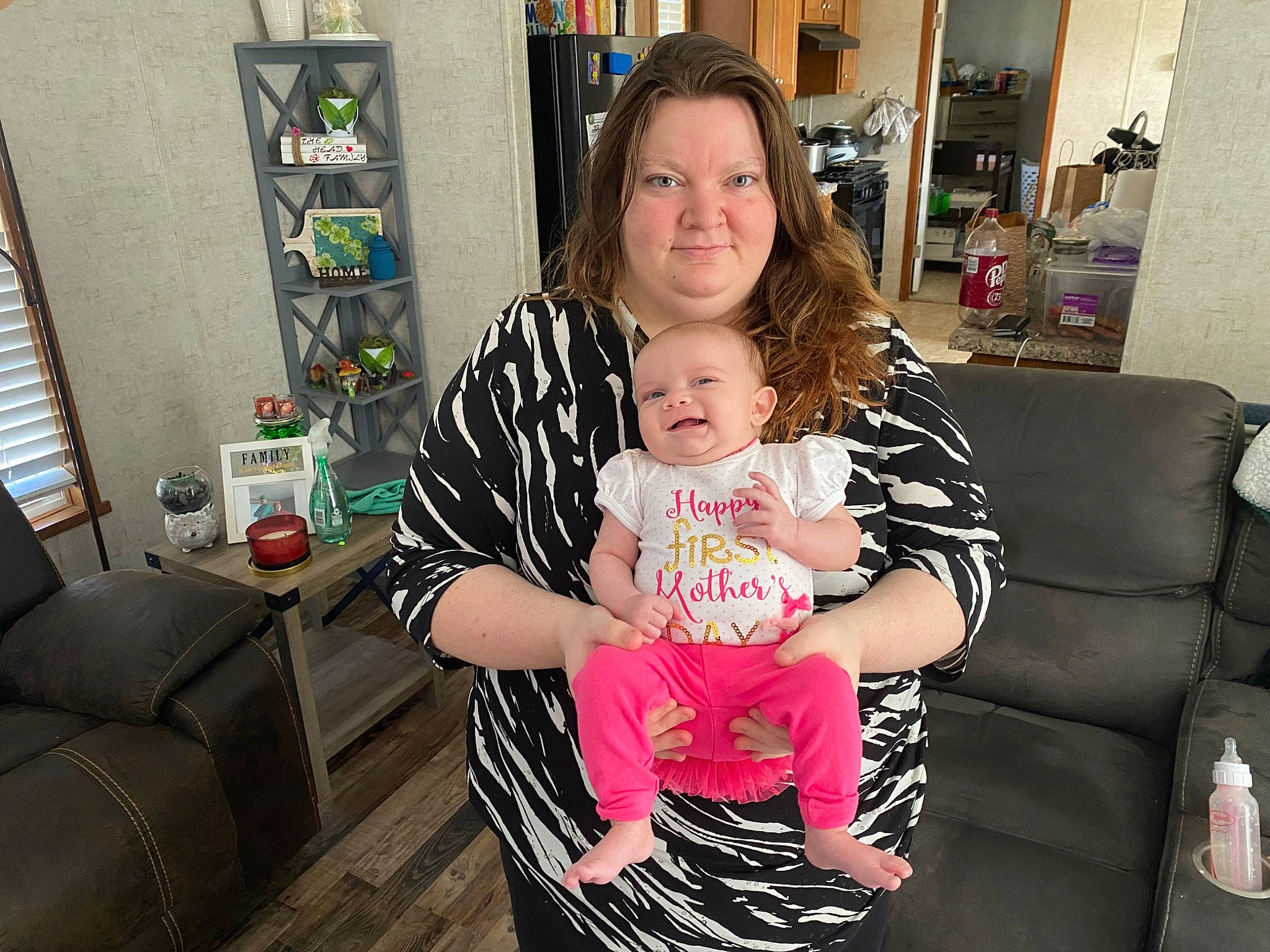 Serenity is registered to the contest to win money with this photo: arm, baby, baby_toddler_clothing, child, comfort, couch, event, eye, fun, happy, joy, living_room, person, picture_frame, room, sitting, skin, sleeve, smile, t_shirt