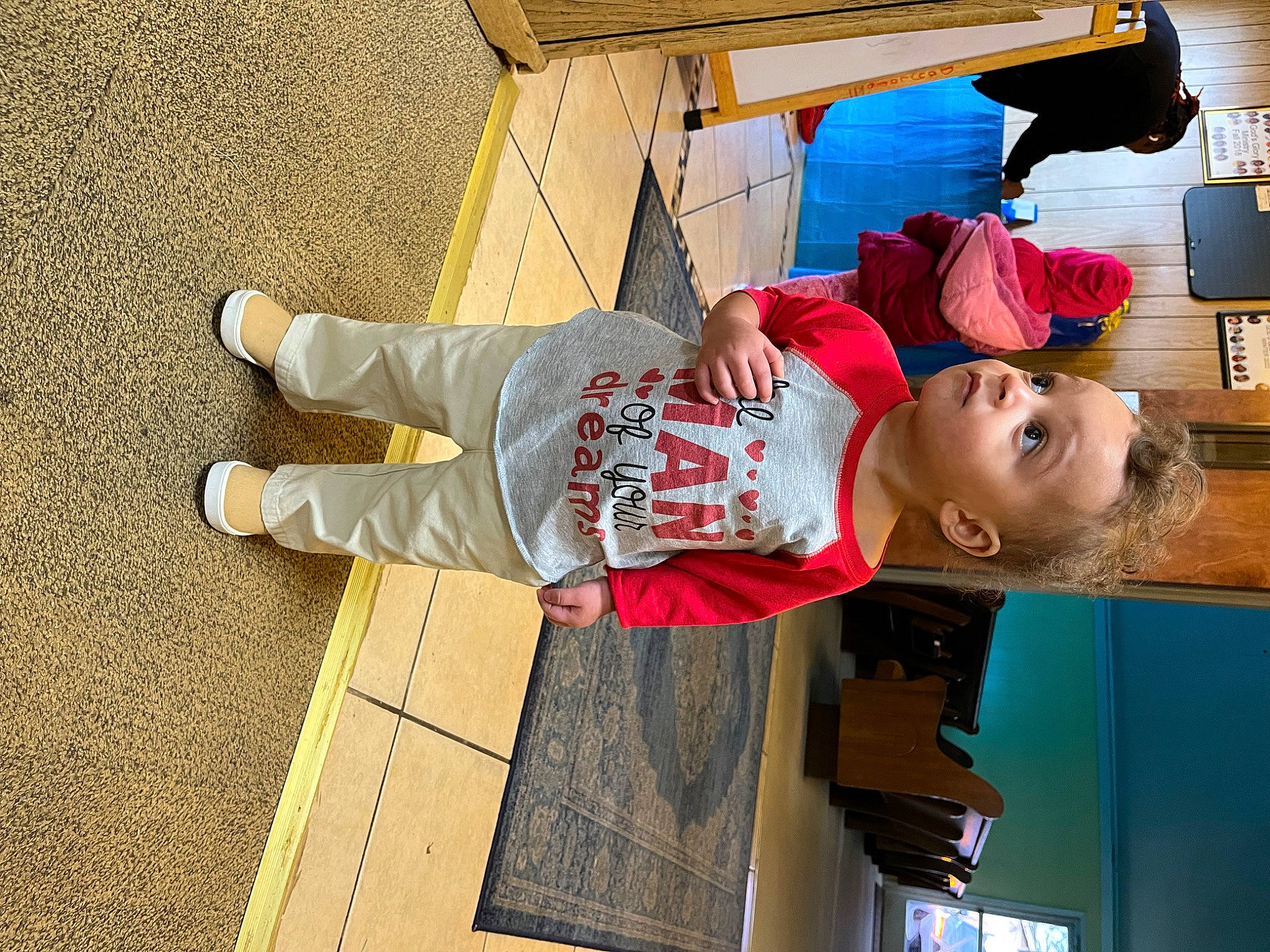 Kyson is registered to the contest to win money with this photo: child, flooring, fun, happy, hat, leisure, lipstick, magenta, person, play, t_shirt, toddler, travel, walking_shoe, wood