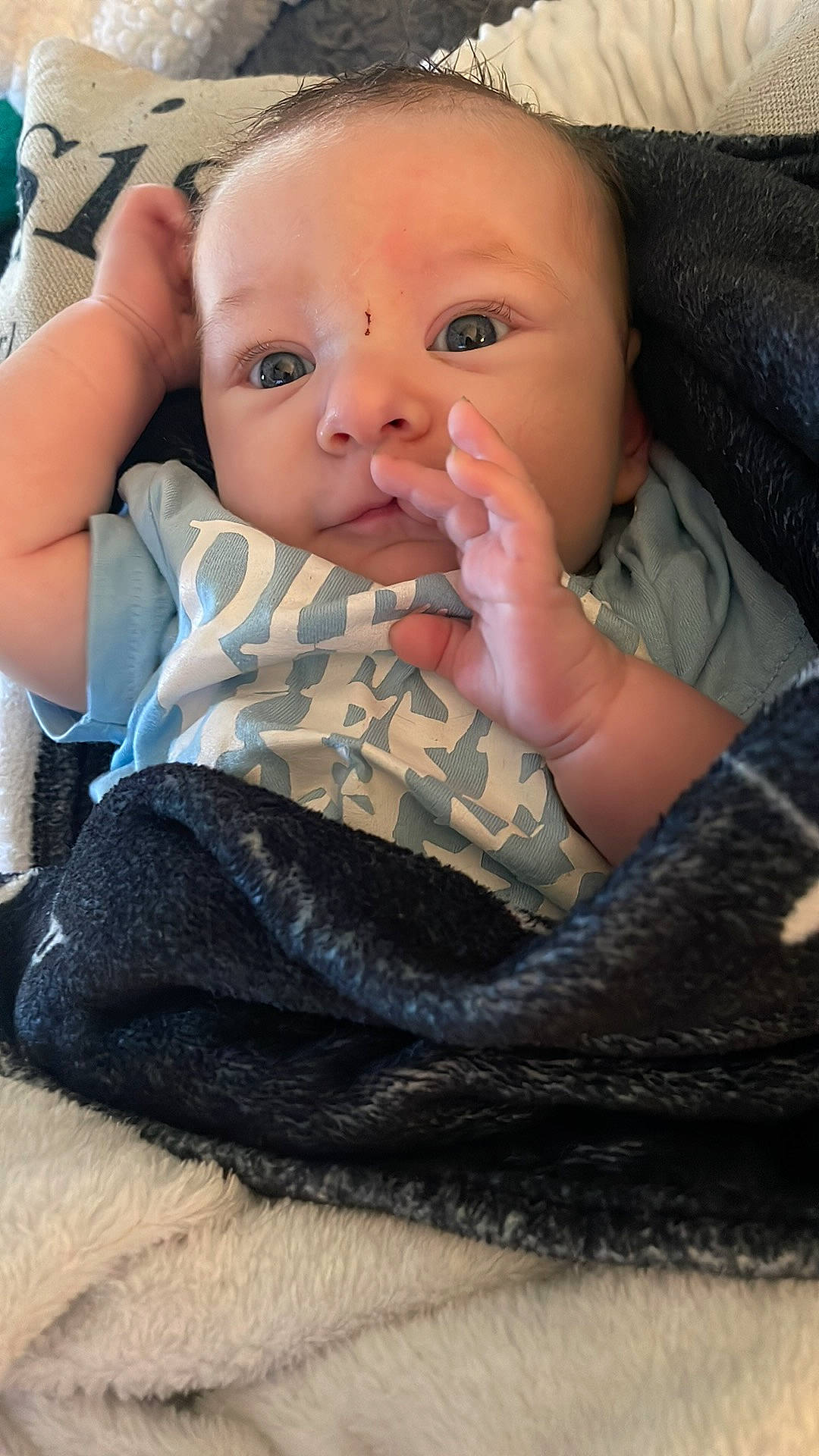 William is registered to the contest to win money with this photo: baby, baby_products, baby_toddler_clothing, cheek, chest, child, comfort, finger, iris, leg, linens, lip, nail, pattern, person, sitting, skin, sleeve, textile, thumb