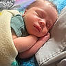 arms, baby, bed, bedding, blanket, closed_eyes, colorful, cozy, face, hands, indoors, infant, nap, newborn, peaceful, portrait, resting, skin, sleeping, soft_lighting