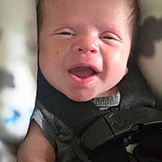 Kaden joined the competition — help win amazing prizes! newborn, baby, infant, child, face, portrait, smiling, awake, car_seat, harness, gray_clothing, pacifier, seated, close_up, indoors, soft_background, natural_light, adorable, head, photography