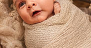 Oakley joined the competition — help win amazing prizes! baby, newborn, wrapped, blanket, knit, cozy, infant, portrait, face, cute, soft, warm, texture, closeup, child, sleeping_bag, indoors, person, adorable, resting