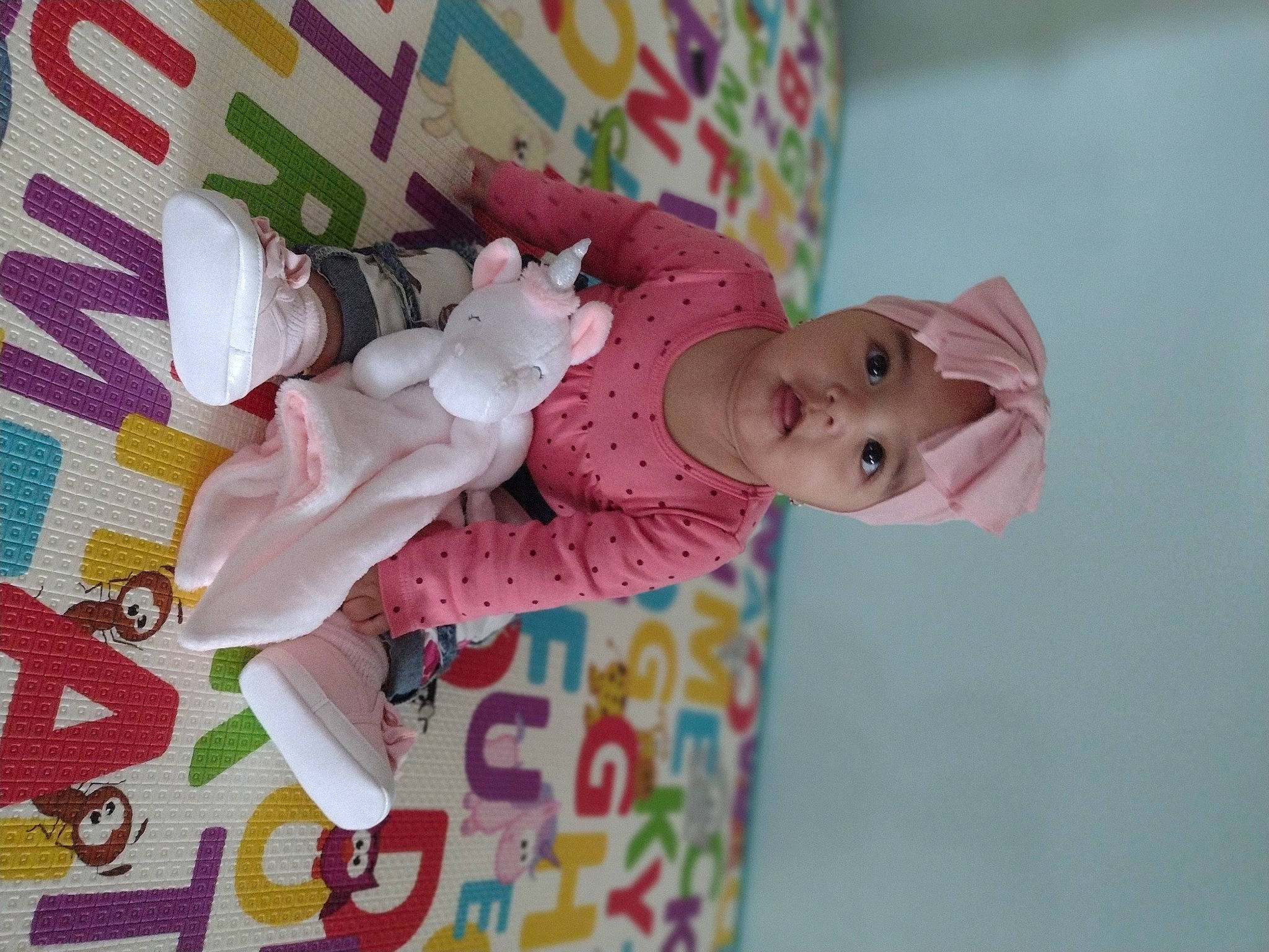 Emily is registered to the contest to win money with this photo: baby, baby_products, baby_toddler_clothing, baby_toys, child, doll, eyelash, fashion_accessory, headwear, linens, magenta, nightwear, pattern, peach, person, pink, room, sleeve, textile, toddler