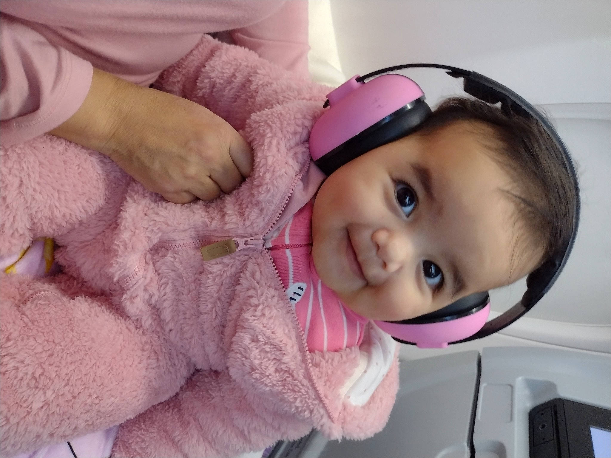 Emily is registered to the contest to win money with this photo: baby, baby_toddler_clothing, cheek, comfort, eyelash, flash_photography, happy, headgear, helmet, iris, lip, magenta, nose, person, pink, purple, skin, sleeve, smile, toddler