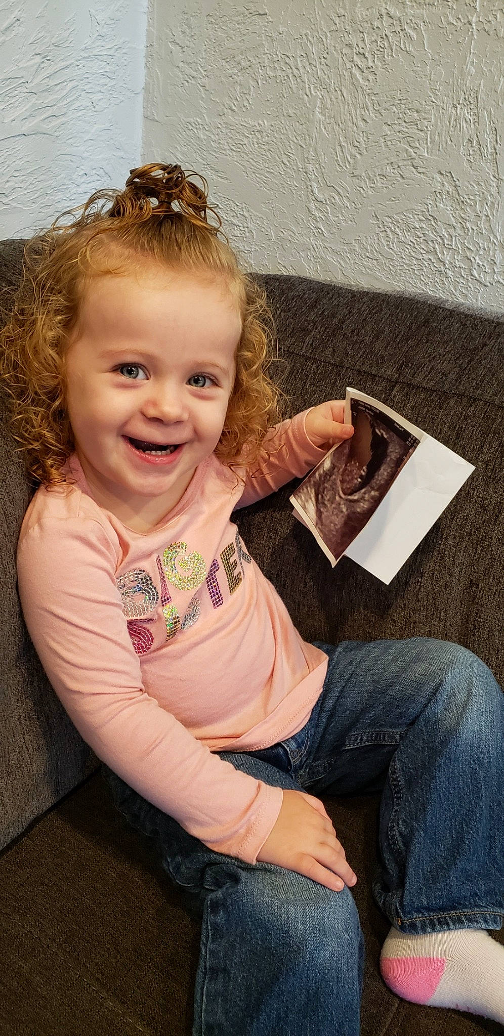 Merida is registered to the contest to win money with this photo: baby, blond, brown_hair, child, child_model, floor, joy, person, play, reading, sitting, smile, toddler