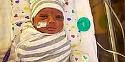 Kameran joined the competition — help win amazing prizes! newborn, baby, hospital, crib, swaddle, striped_clothing, hat, bear_ears, medical_tubes, monitoring_equipment, pillow, heart_pattern, infant, lying_down, face, cute, patient, healthcare, wrapped, small