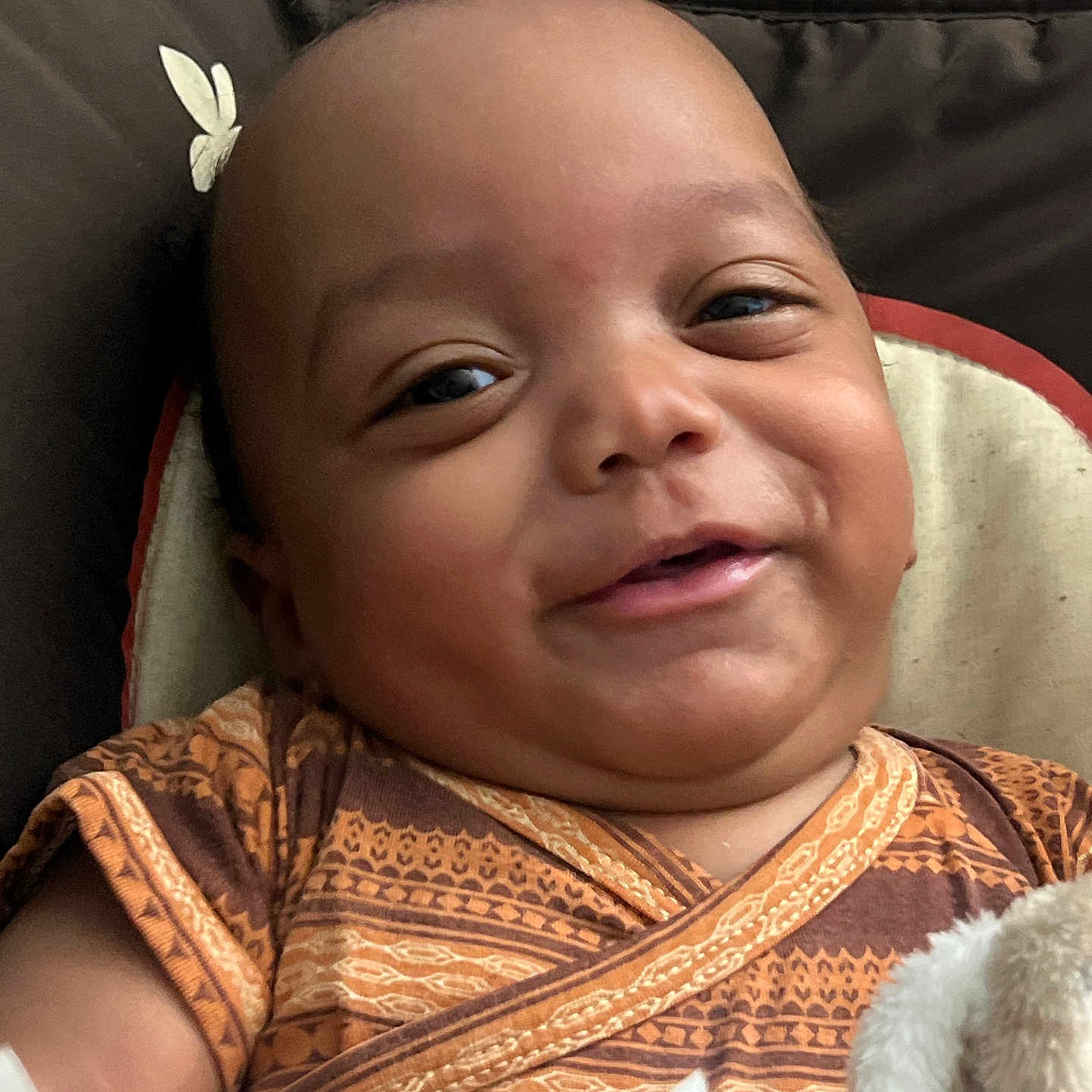 Kameran is registered to the contest to win money with this photo: baby, babywear, blanket, child, closeup, clothing, comfort, cushion, expression, face, happy, head, indoors, infant, patterned_clothes, person, portrait, skin, smile, young_child