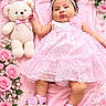 Ailany is registered to the contest to win money with this photo: baby, infant, child, portrait, pink, dress, headband, flower, roses, teddy_bear, stuffed_animal, blanket, lying_down, smiling, face, fashion, floral, nursery, studio_photo, cute