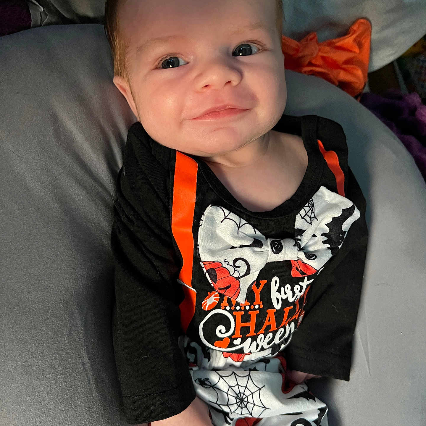 Joseph is registered to the contest to win money with this photo: baby, bodypart, clothing, couch, cushion, face, finger, frown, furniture, hand, happy, head, homedecor, pants, person, photography, portrait, sitting, smile, t_shirt