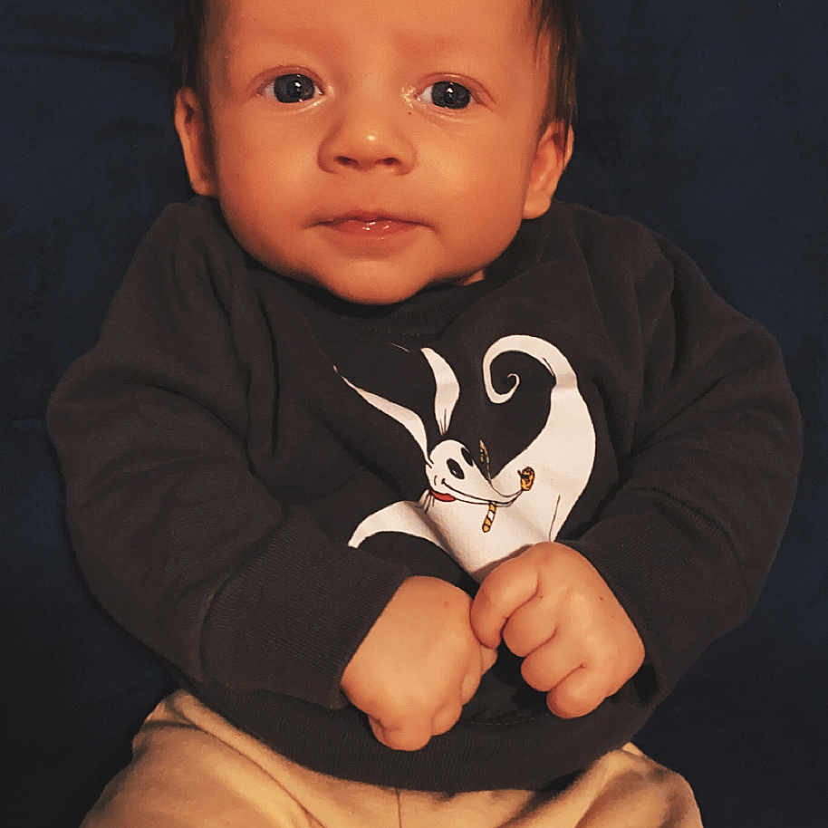 Keanu joined the competition — help win amazing prizes! baby, bodypart, clothing, face, finger, hand, happy, head, hoodie, knitwear, longsleeve, pants, person, photography, portrait, sitting, sleeve, smile, sweater, sweatshirt