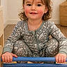 toddler, child, smiling, indoor, wooden_toy, colorful, play, pajamas, hands, feet, hair, face, happy, person, furniture, room, floor, skin, cute, young