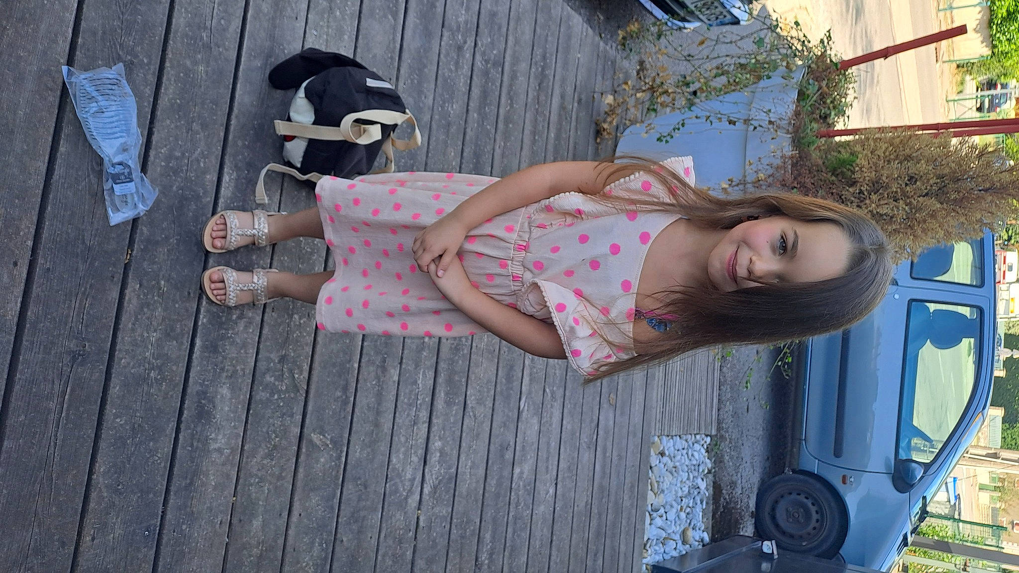 Krystal participe au concours pour gagner de l'argent avec cette photo : automotive_exterior, car, dress, eyewear, foot, human_leg, joy, leg, pattern, person, pink, plant, sandal, sidewalk, thigh, tire, tree, vehicle, vehicle_door, waist